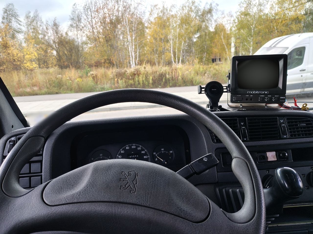 View from the driver's seat of a Peugeot van: the RV-50 monitor stands on the right side of the dashboard